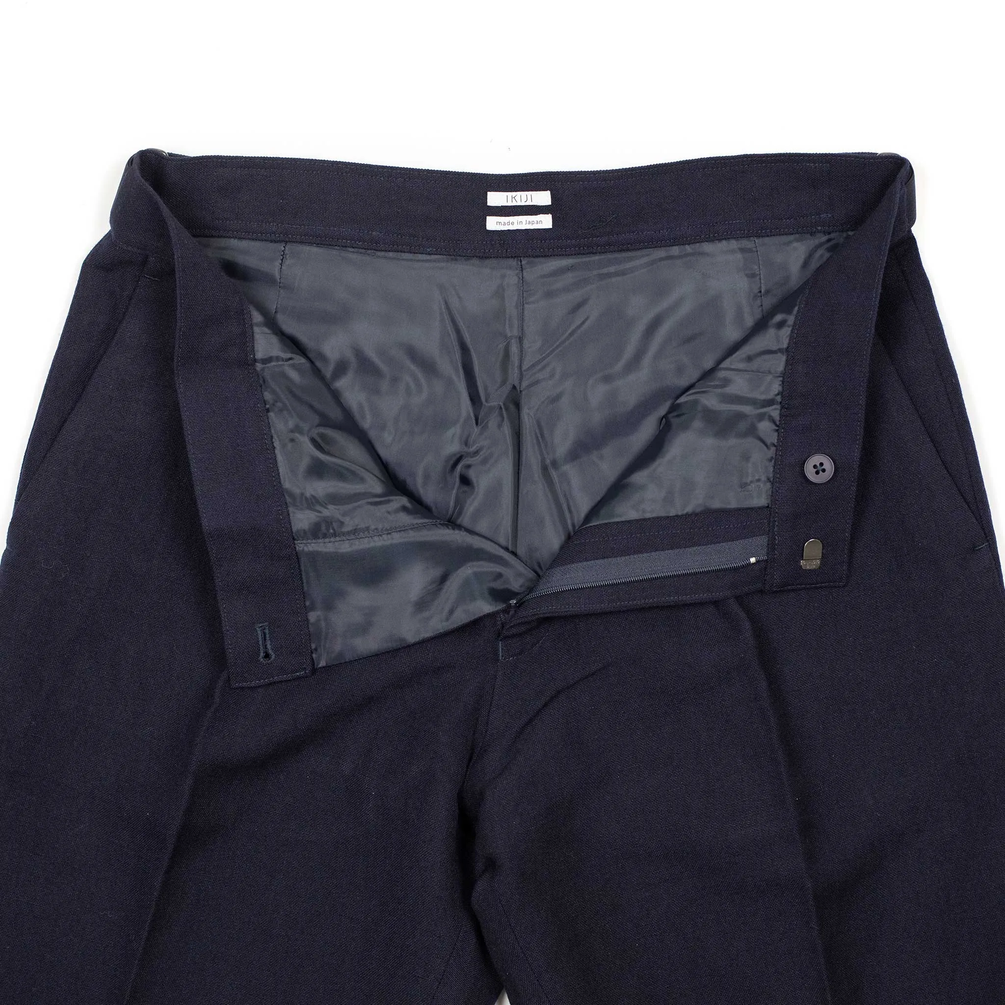 Side tab pleated trousers in dark navy soft wool and linen oxford